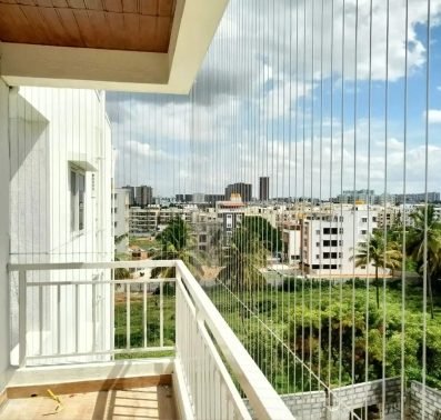 Invisible stainless-steel safety grill on a balcony