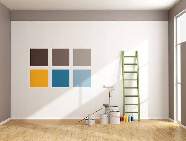 Freshly painted interior wall with colour swatches and ladder